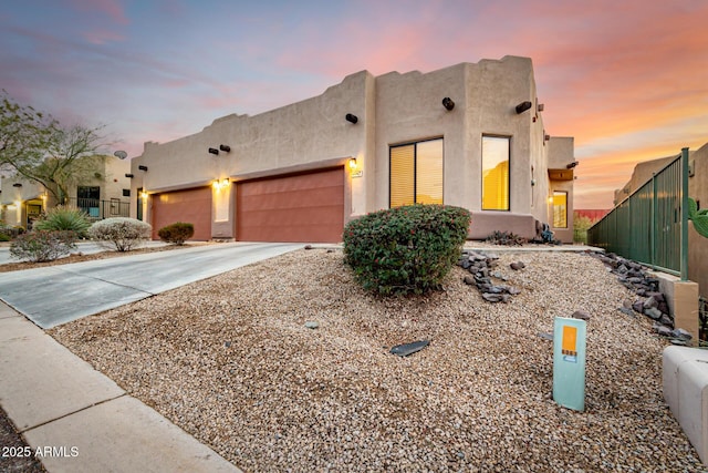 pueblo-style house with a garage