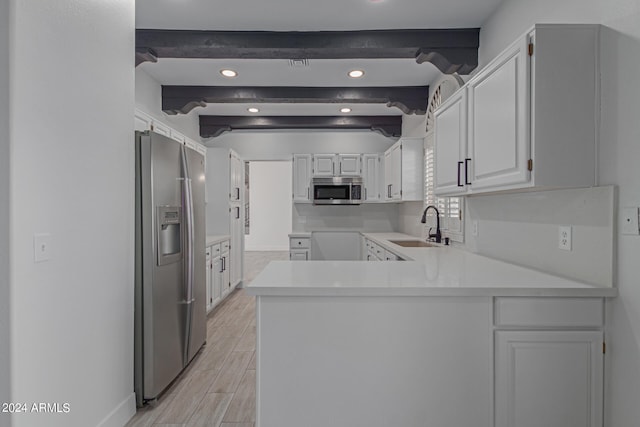 kitchen featuring light wood-type flooring, beamed ceiling, sink, white cabinetry, and stainless steel appliances