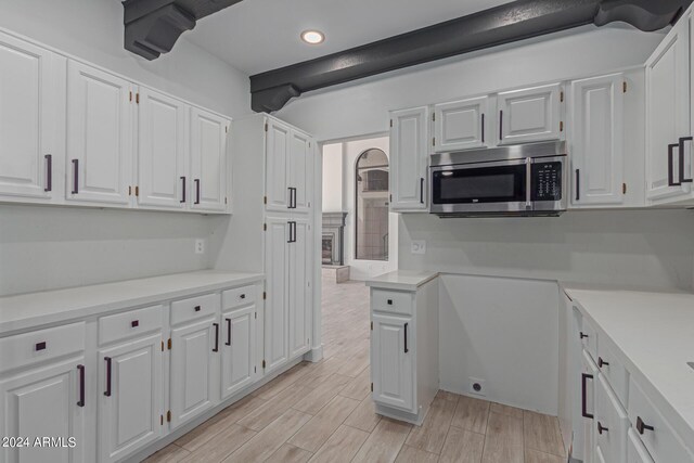 kitchen featuring white cabinets and light wood-type flooring