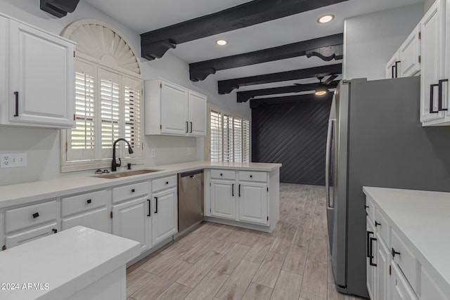 kitchen with beamed ceiling, sink, light hardwood / wood-style flooring, white cabinetry, and stainless steel appliances