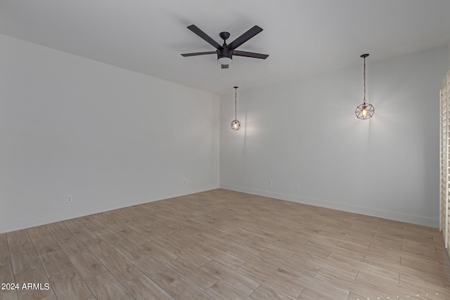 unfurnished room featuring ceiling fan and light wood-type flooring