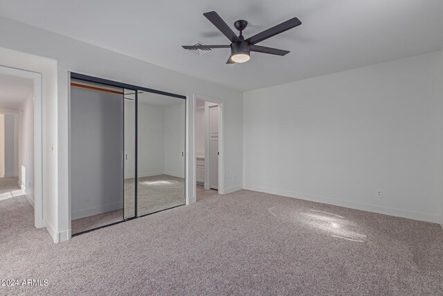 unfurnished bedroom featuring ceiling fan and light colored carpet