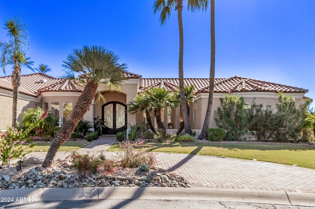 mediterranean / spanish house featuring french doors