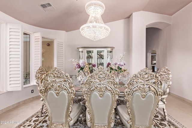 tiled dining space with lofted ceiling and a notable chandelier