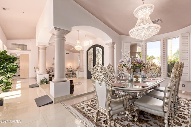 tiled dining space with vaulted ceiling, decorative columns, and an inviting chandelier