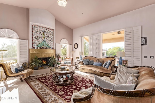 living room with a high end fireplace, high vaulted ceiling, tile patterned floors, and ceiling fan