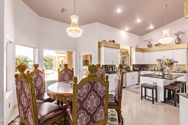 tiled dining room with a chandelier and a high ceiling