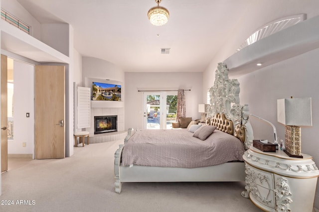 bedroom featuring carpet floors and a tiled fireplace