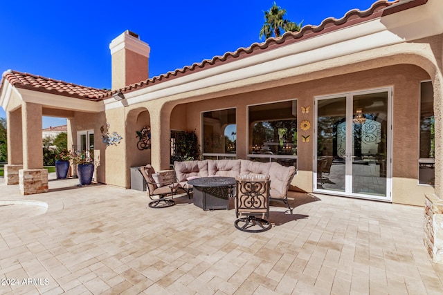 view of patio / terrace with french doors and an outdoor living space with a fire pit