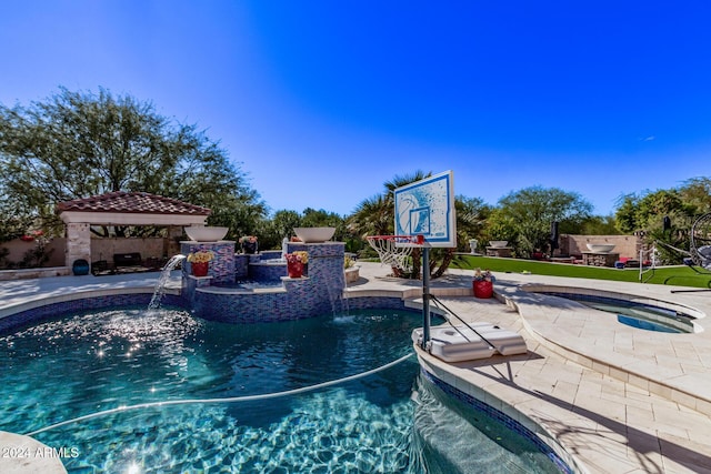 view of swimming pool featuring an in ground hot tub, a gazebo, pool water feature, and a patio area