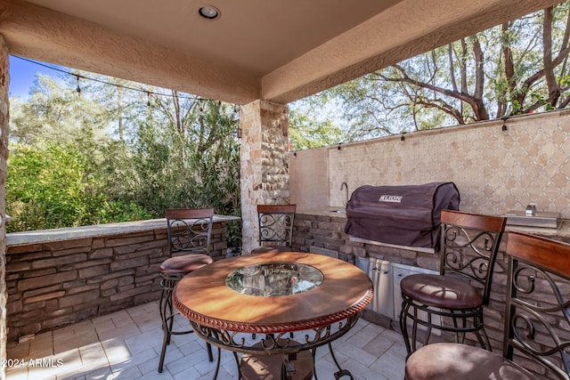 view of patio featuring area for grilling and an outdoor fire pit