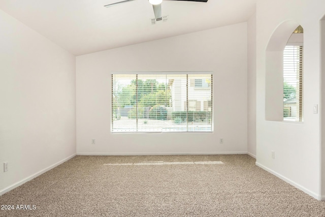 spare room with lofted ceiling, plenty of natural light, visible vents, and carpet floors