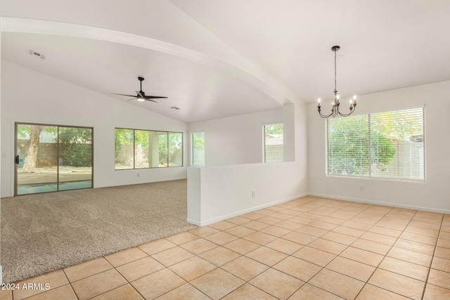 spare room with visible vents, vaulted ceiling, light carpet, light tile patterned floors, and ceiling fan with notable chandelier