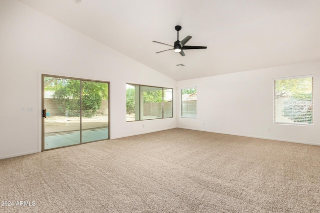 carpeted empty room with visible vents, high vaulted ceiling, and ceiling fan