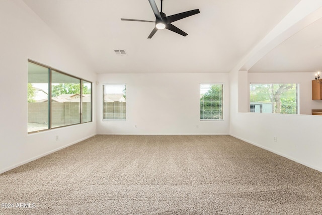 spare room with visible vents, baseboards, carpet, and vaulted ceiling