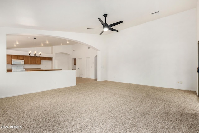 unfurnished living room featuring visible vents, light carpet, ceiling fan with notable chandelier, and vaulted ceiling