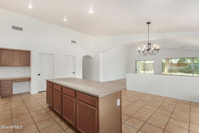 kitchen with visible vents, a center island, light countertops, light tile patterned floors, and a notable chandelier