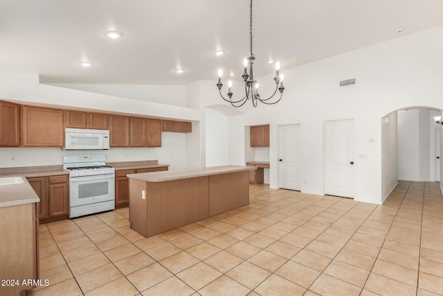 kitchen with visible vents, white appliances, arched walkways, light countertops, and light tile patterned floors