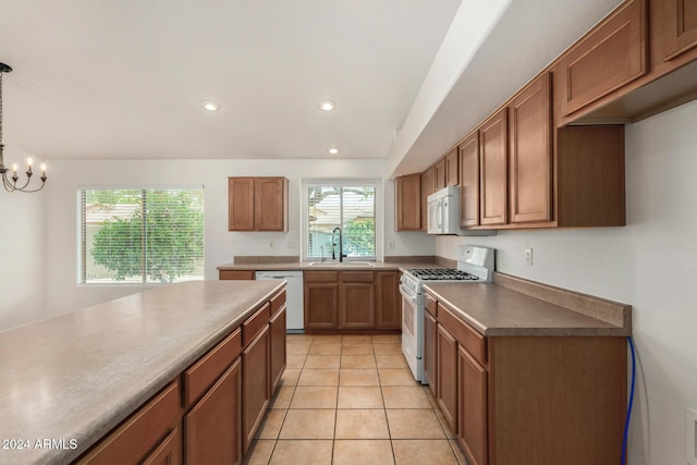 kitchen with a sink, recessed lighting, white appliances, light tile patterned flooring, and brown cabinetry