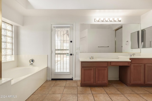 full bath with tile patterned floors, a bath, double vanity, and a sink