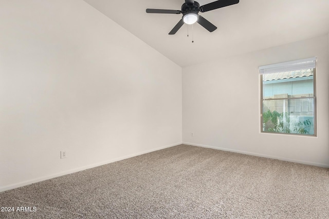 carpeted empty room featuring lofted ceiling, a ceiling fan, and baseboards