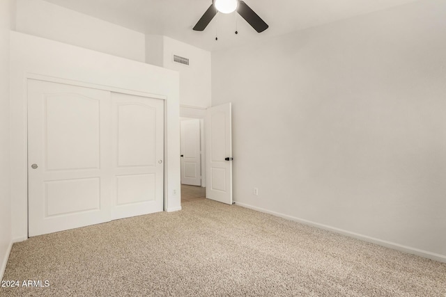 unfurnished bedroom with visible vents, baseboards, carpet, a closet, and a ceiling fan