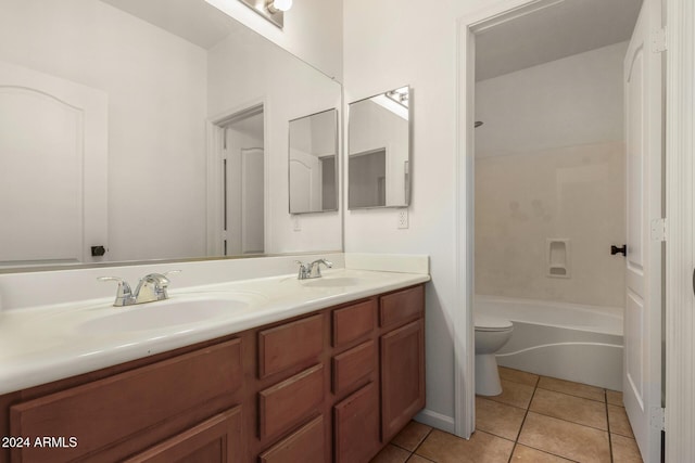 bathroom with tile patterned flooring, double vanity, toilet, and a sink