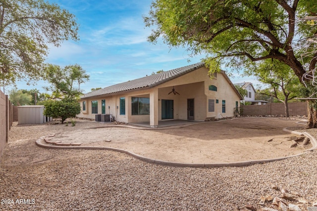 rear view of property with stucco siding, a patio, a fenced backyard, ceiling fan, and a tiled roof