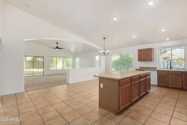 kitchen featuring dishwasher, lofted ceiling, light tile patterned flooring, and a sink