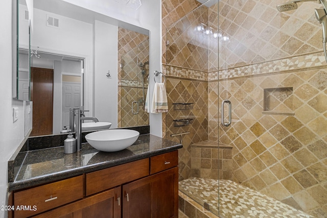 bathroom featuring vanity and an enclosed shower