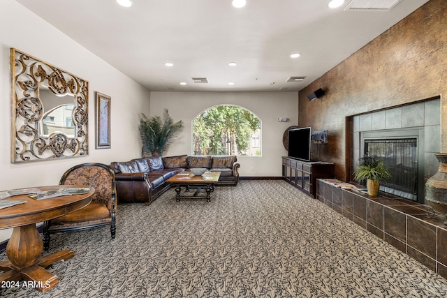 carpeted living room with a tile fireplace