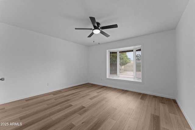 empty room featuring ceiling fan and light hardwood / wood-style flooring