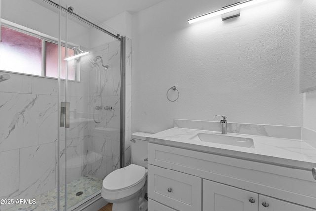 bathroom with vanity, toilet, and a shower with shower door