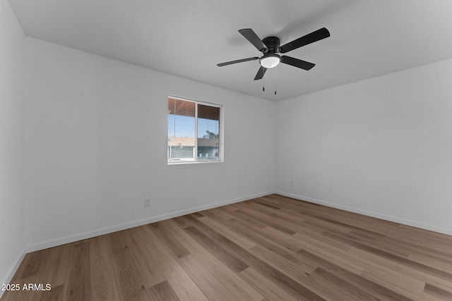 spare room featuring ceiling fan and light hardwood / wood-style flooring