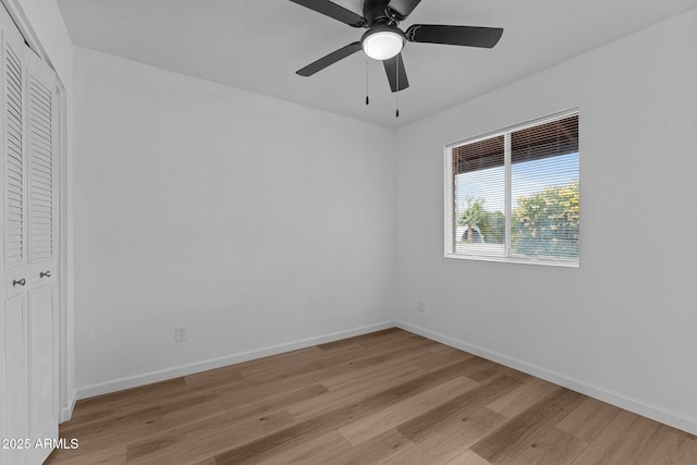 empty room with light wood-type flooring and ceiling fan