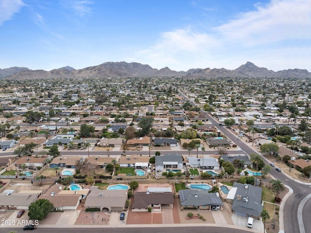 birds eye view of property with a mountain view