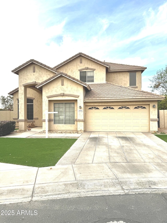 view of front facade featuring a garage, a front yard, concrete driveway, and stucco siding