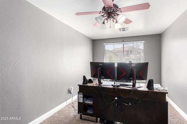 office featuring carpet, visible vents, and baseboards