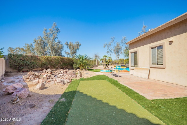 view of yard with a patio area, a fenced backyard, and a fenced in pool