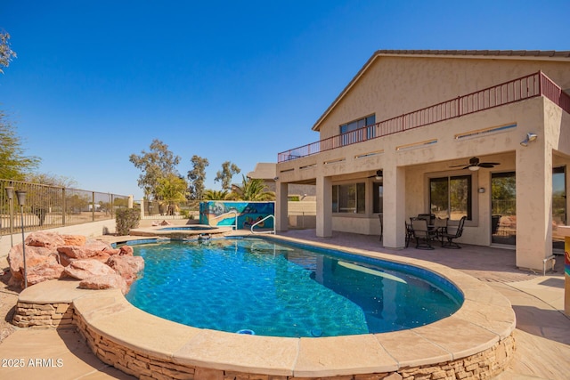 view of swimming pool with a fenced in pool, ceiling fan, an in ground hot tub, fence, and a patio area