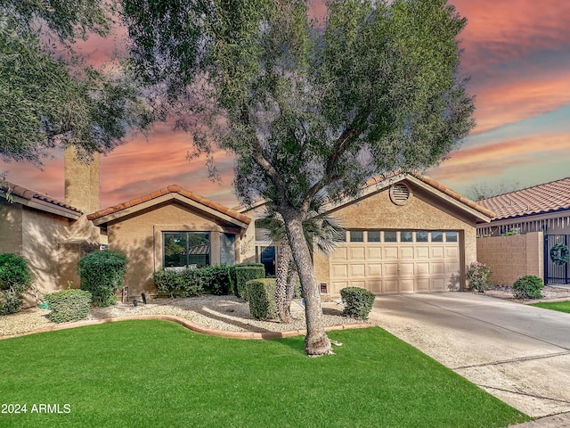 view of front of home featuring a yard and a garage