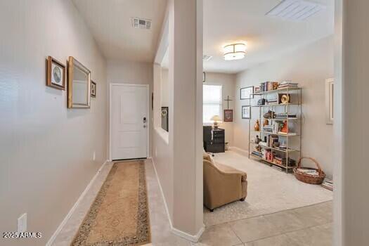 hall featuring light colored carpet