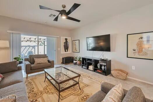 living room featuring ceiling fan and carpet