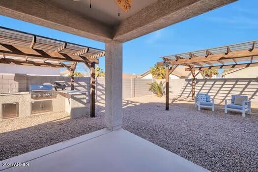 view of patio / terrace featuring an outdoor kitchen, ceiling fan, a pergola, and grilling area