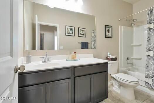 full bathroom with vanity, shower / bath combination with curtain, and toilet