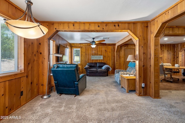 3384 Turkey Run, Overgaard, AZ 85933 - living room with wood walls, carpet, and a ceiling fan