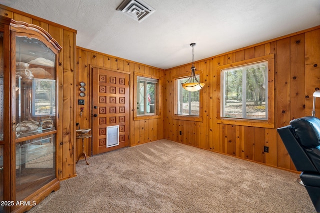 3384 Turkey Run, Overgaard, AZ 85933 - unfurnished dining area with carpet and wood walls