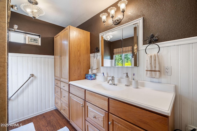 3384 Turkey Run, Overgaard, AZ 85933 - bathroom featuring wood finished floors, vanity, wainscoting, and a chandelier