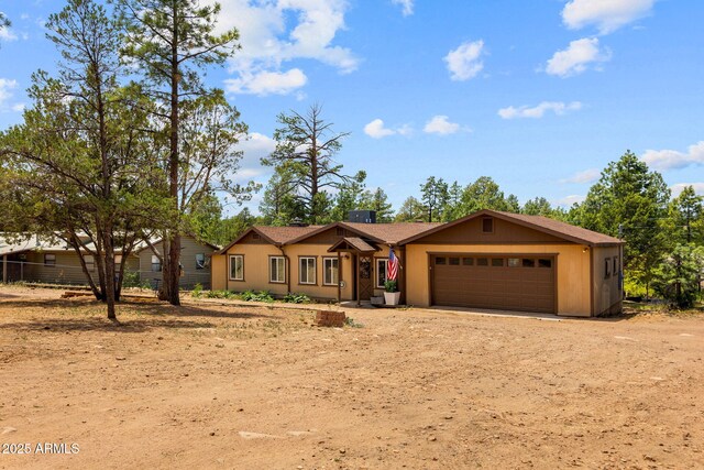3384 Turkey Run, Overgaard, AZ 85933 - single story home featuring an attached garage and dirt driveway