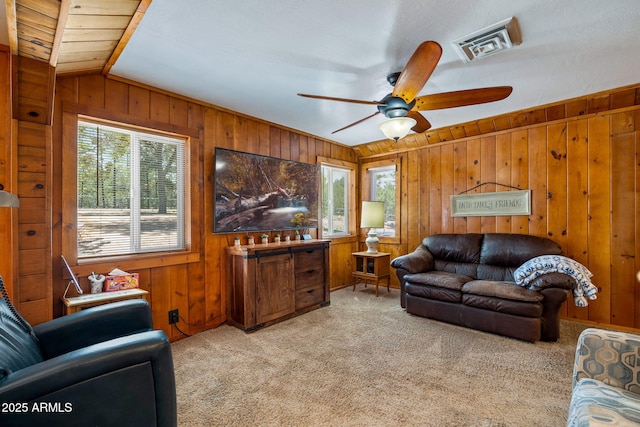 3384 Turkey Run, Overgaard, AZ 85933 - living room featuring healthy amount of natural light, wood walls, carpet, and a ceiling fan